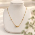 گردنبند طلا هرمس و گوی تراش روی استند کرم
